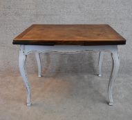 A distressed painted French style draw leaf dining table with oak parquetry top H.70x102x75cm (ext.
