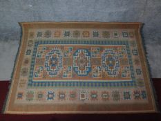 A shiraz style rug with triple geometric medallions on a chestnut ground contained by geometric