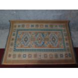 A shiraz style rug with triple geometric medallions on a chestnut ground contained by geometric