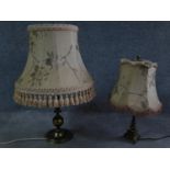 A pair of antique solid brass table lamps, one with a triangular base on three feet and one with a