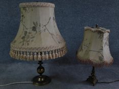 A pair of antique solid brass table lamps, one with a triangular base on three feet and one with a