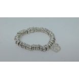 A silver Links of London bracelet with Links logo charm. Weight 42g.