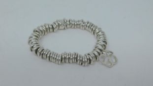 A silver Links of London bracelet with Links logo charm. Weight 42g.