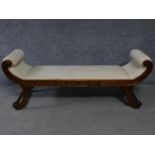 A Regency style mahogany window seat on swept supports. H.65 W.165 D.48cm