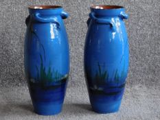 A large pair of twisted handled Watcombe Torquay pottery vases, the blue ground painted with