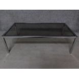 A chromium framed smoked glass plate top coffee table. H.35 W.114 D.59cm