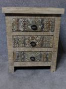 An Eastern carved hardwood bedside chest of three drawers on block feet. H.60 W.50 D.40cm