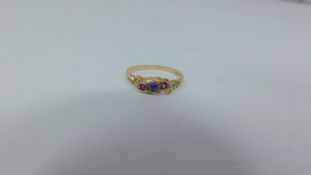 A 9ct gold opal and pink stone ring, set with a central round cabochon opal flanked by two round