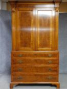 A Georgian style yew and walnut crossbanded armoire with panel doors above four graduating drawers