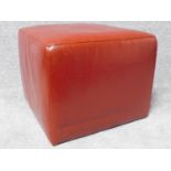 A red leather cubiform footstool. H.42 W.52 D.52cm