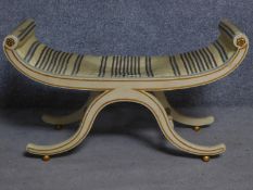 A painted Regency style upholstered window seat on swept stretchered supports. H.58 W.101 D.37cm