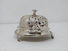 A Victorian silver pierced desk bell with stylised floral design and stylised four petal flower to