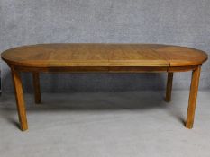 An American walnut extending dining table on square supports. (includes two leaves) H.74 W.209 D.