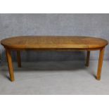 An American walnut extending dining table on square supports. (includes two leaves) H.74 W.209 D.