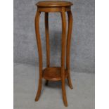 A late Victorian oak jardiniere stand on square section cabriole supports united by undertier. H.