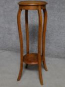 A late Victorian oak jardiniere stand on square section cabriole supports united by undertier. H.