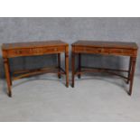 A pair of Georgian style yew hall tables with three frieze drawers on square stretchered supports.