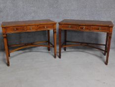 A pair of Georgian style yew hall tables with three frieze drawers on square stretchered supports.