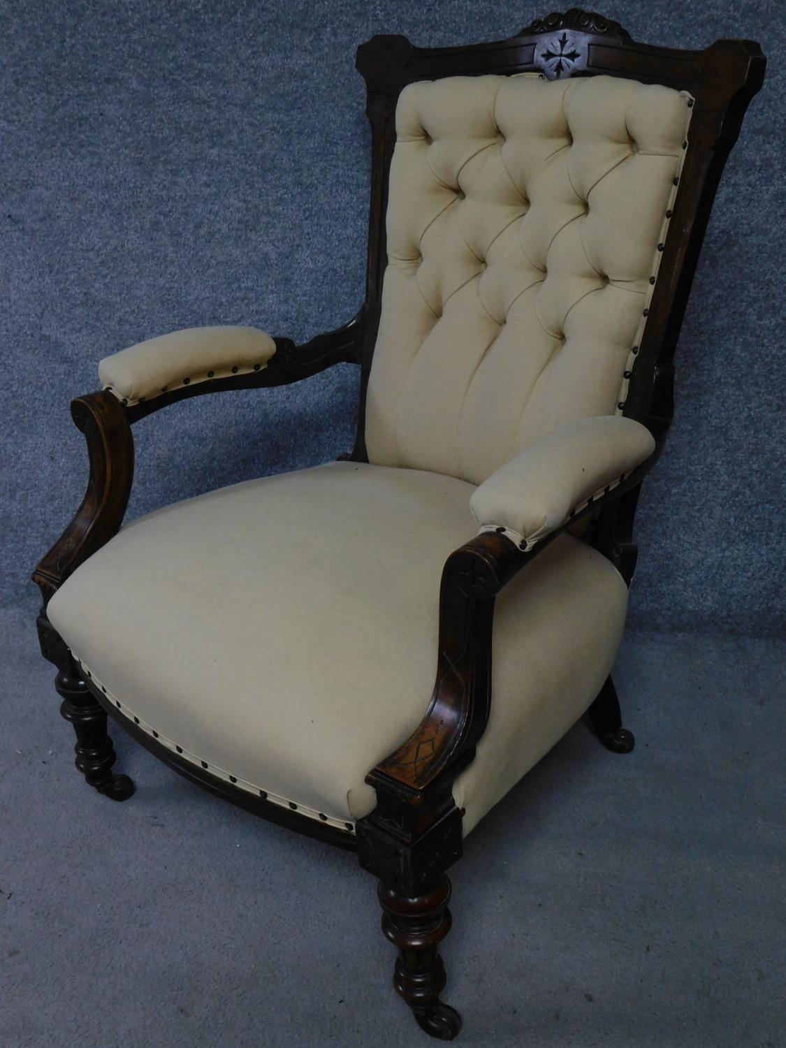 A late Victorian carved walnut armchair on turned tapering supports terminating in ceramic - Image 2 of 5