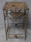 A wrought iron conservatory occasional table on stretchered supports. H.63 W.38 D.38cm