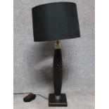A carved wood and metal collared table lamp with square base. Fitted with dimmer switch. H.83cm