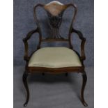 A late 19th century rosewood armchair with ivory and satinwood inlay raised on cabriole supports.