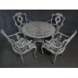 A metal Coalbrookdale style garden table and the matching four armchairs. H.68 W.80 D.80cm (table)