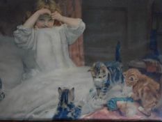 An antique framed and glazed coloured lithograph of a girl and cats. 57x41cm