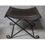 A Continental metal folding stool with leather seat. H.44 W.55 D.49cm