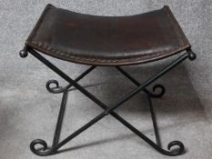 A Continental metal folding stool with leather seat. H.44 W.55 D.49cm