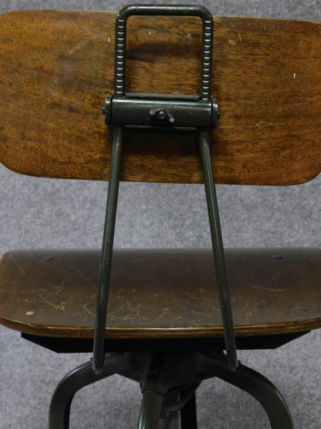 A mid 20th century industrial style metal framed machinist's chair with laminated seat and back. H. - Image 5 of 5