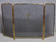 A Regency style brass fireguard with ribbon motif to the centre. 83x133cm