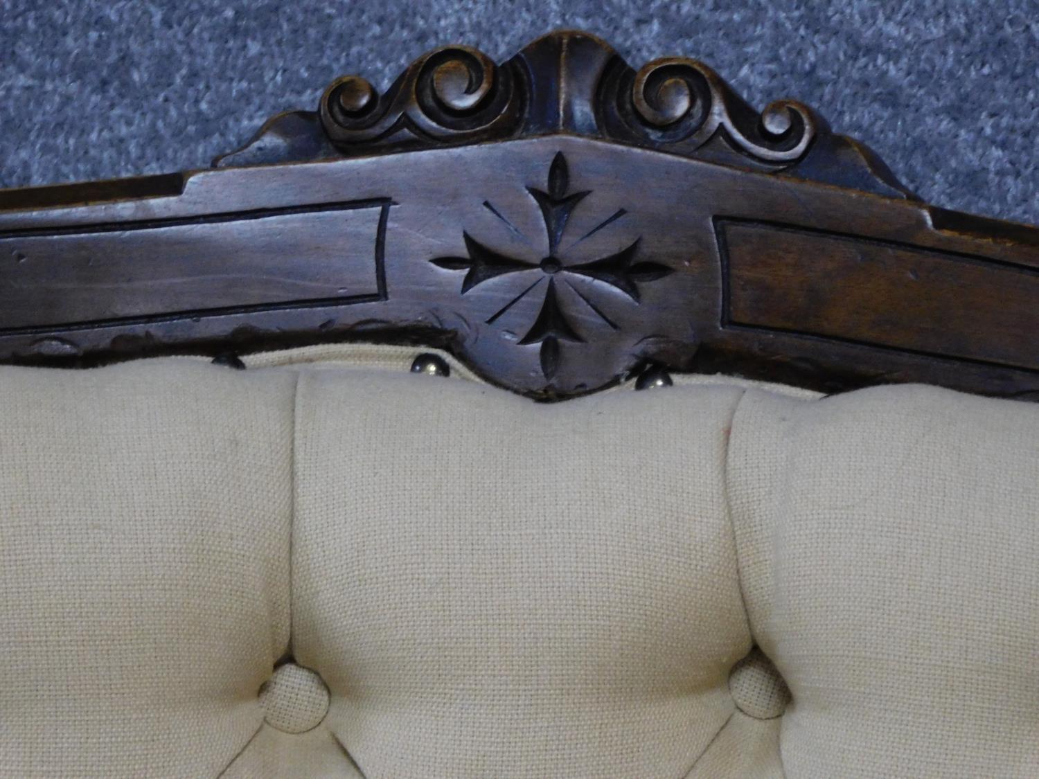 A late Victorian carved walnut armchair on turned tapering supports terminating in ceramic - Image 3 of 5