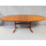A mid 20th century G-Plan style teak extending dining table with leaf fitted to underside. H.72 W.