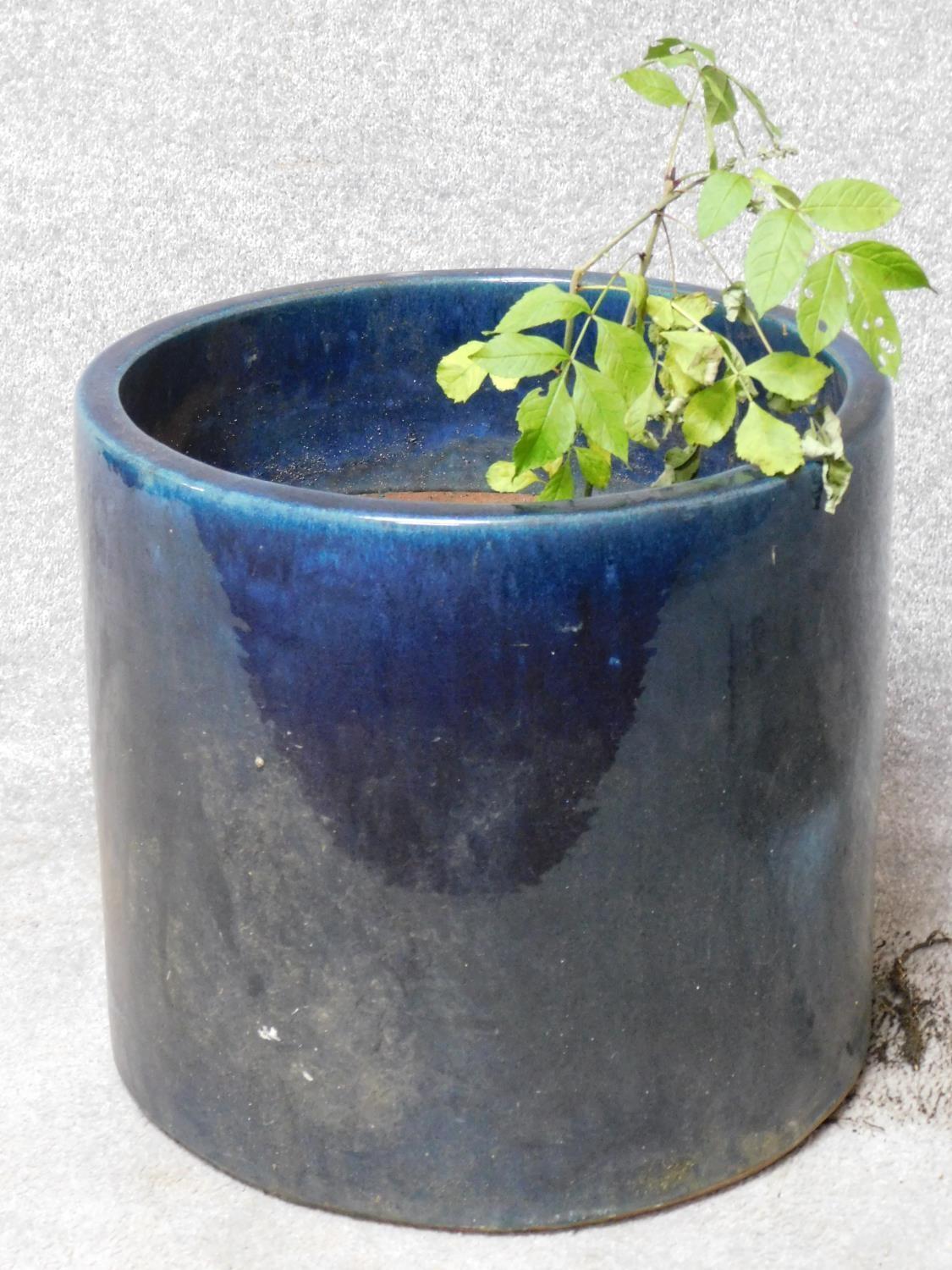 A blue glazed cylindrical garden planter. H.43 W.47 D.47cm