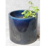 A blue glazed cylindrical garden planter. H.43 W.47 D.47cm