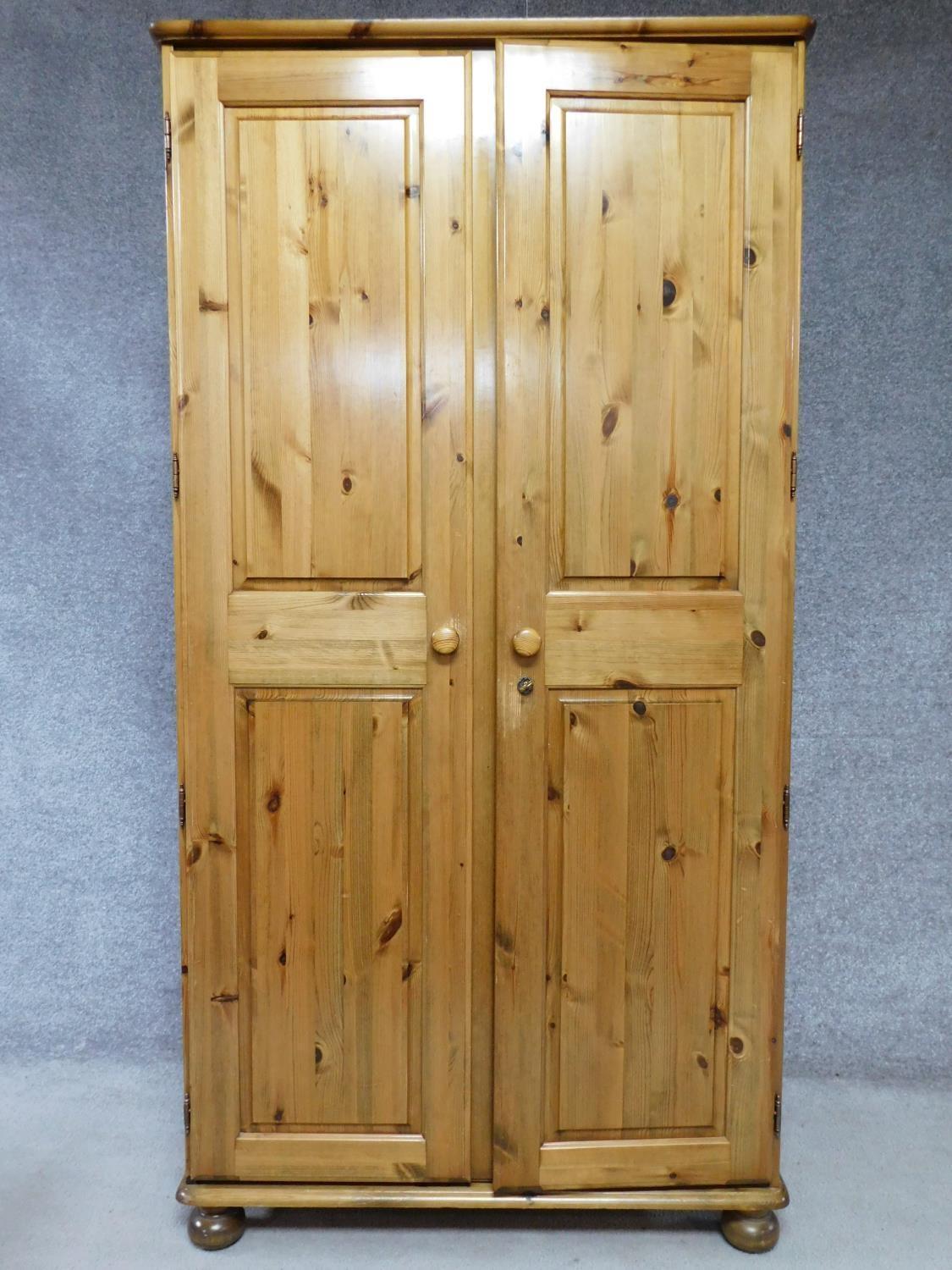 A contemporary pine wardrobe with mirror to interior of panel door. By English maker Victoria. H.183