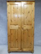 A contemporary pine wardrobe with mirror to interior of panel door. By English maker Victoria. H.183