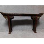 A Chinese hardwood altar table on carved trestle supports. H.93 W.179 D.31cm