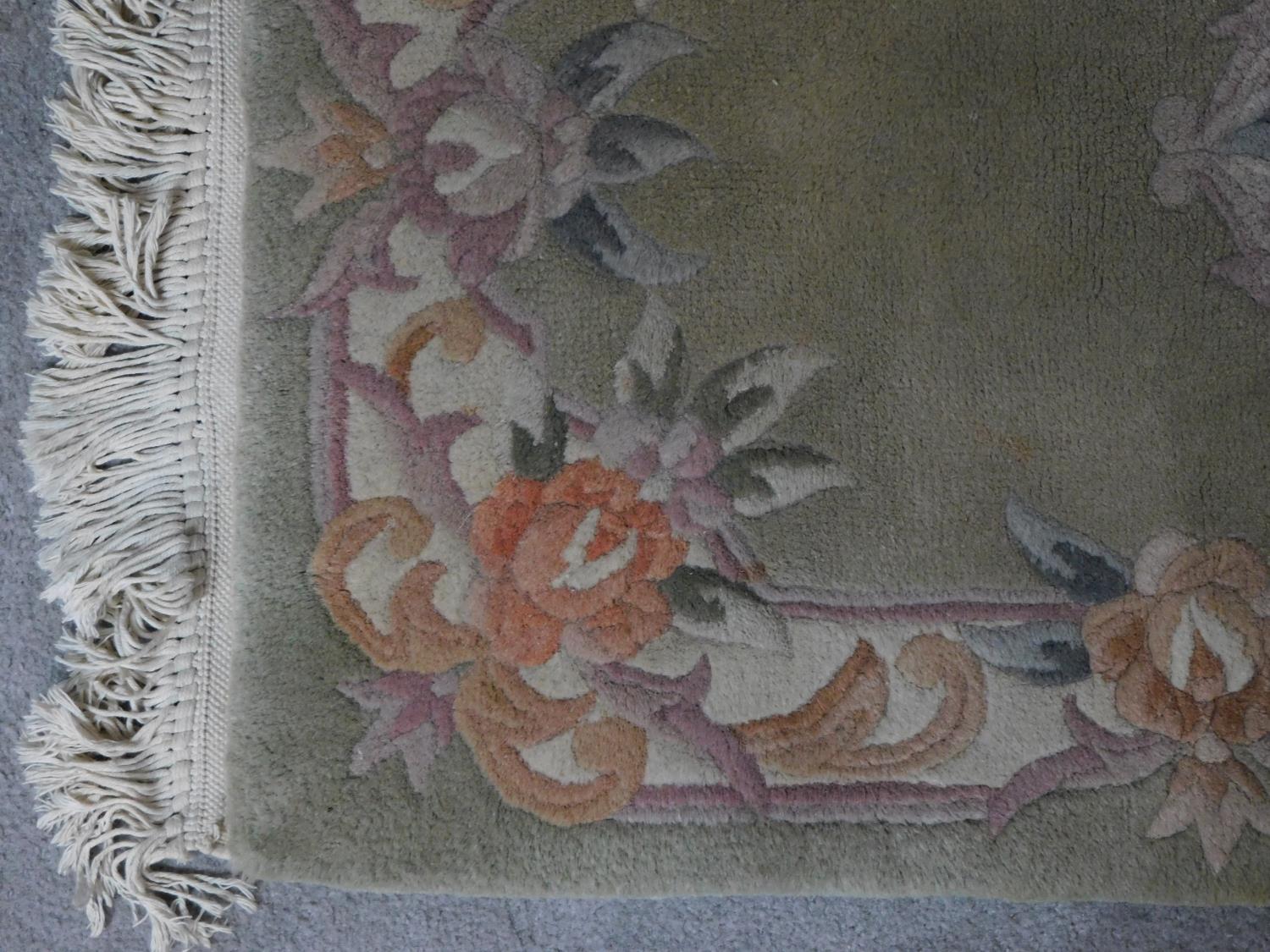 A Chinese rug with central floral medallion set on a pastel field within floral borders 144x63cm - Image 3 of 4
