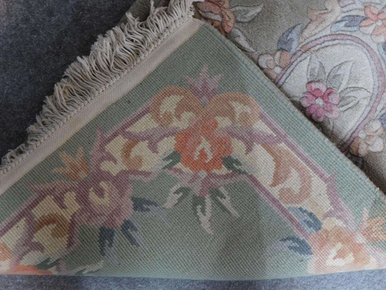 A Chinese rug with central floral medallion set on a pastel field within floral borders 144x63cm - Image 4 of 4