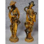 A pair of Chinese style moulded figures. H.49cm