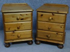 A pair of contemporary pine bedside chests with three drawers on casters, by English maker Victoria.