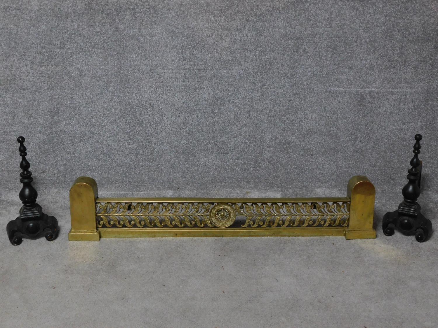 A 19th century brass fire kerb together with a pair of andirons. H.110cm