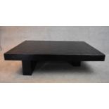A large contemporary black lacquered coffee table on block supports. H.38x160x110cm