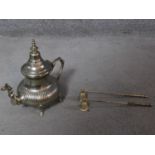 A silver plate Moroccan tea pot and two silver plate candle snuffers. H.26cm