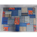 A modern geometric style rug of patchwork design. 200x141cm