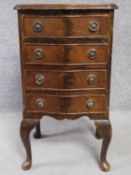 A Georgian style flame mahogany chest of four drawers on cabriole supports. H.74 W.41 D.36cm