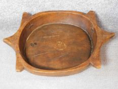 A vintage African yellow wood bowl with carved abstract design and engraved detailing. 57x41cm