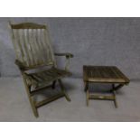 A weathered teak folding garden chair together with a matching folding table. H.103cm